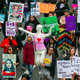 People honoring International Women’s Day on Sunday in Los Angeles. Image via AP.